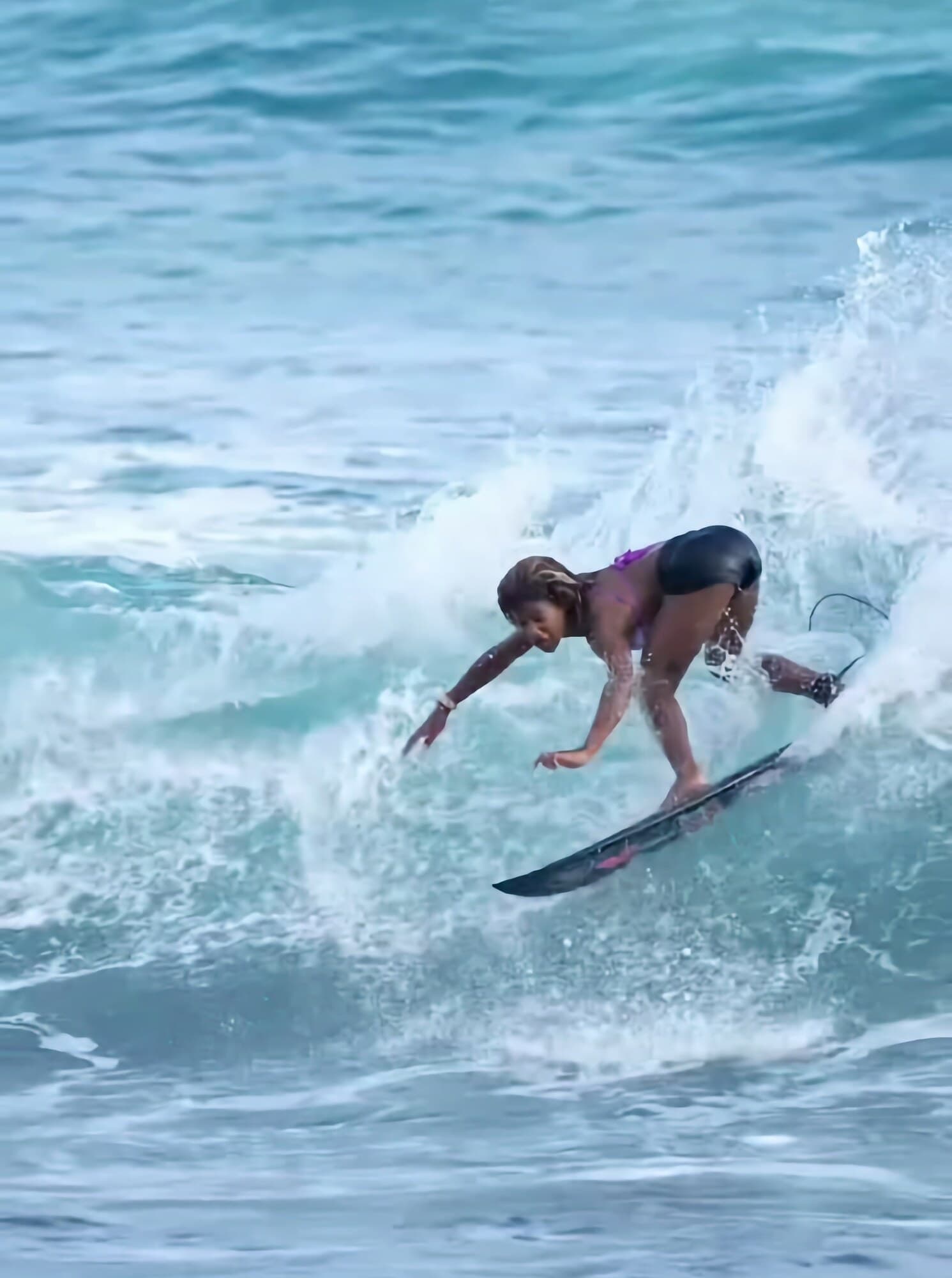 A Journey student surfing a wave on the Pacific coast near the Jacó campus