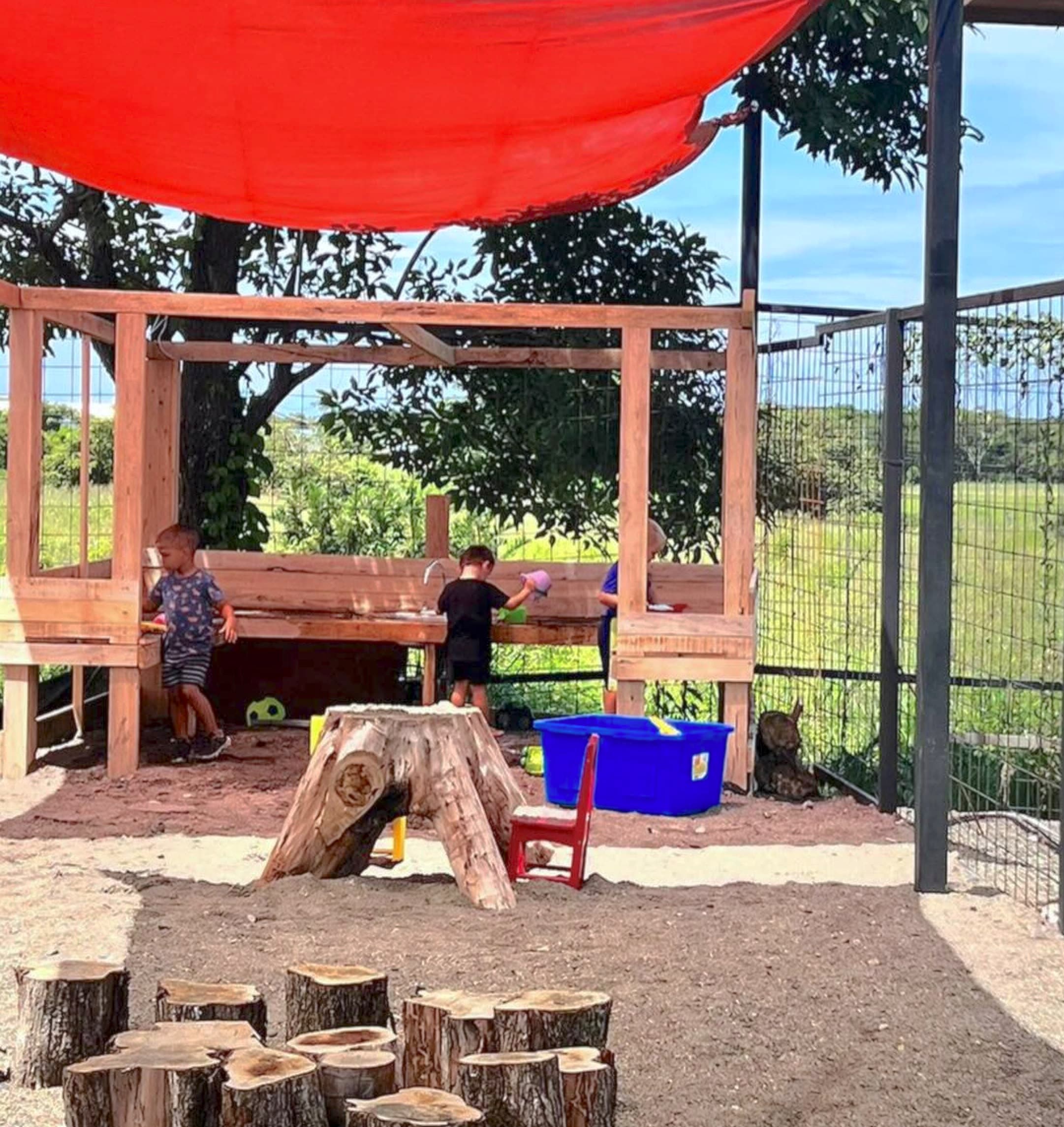 Children playing at outdoor mud kitchen