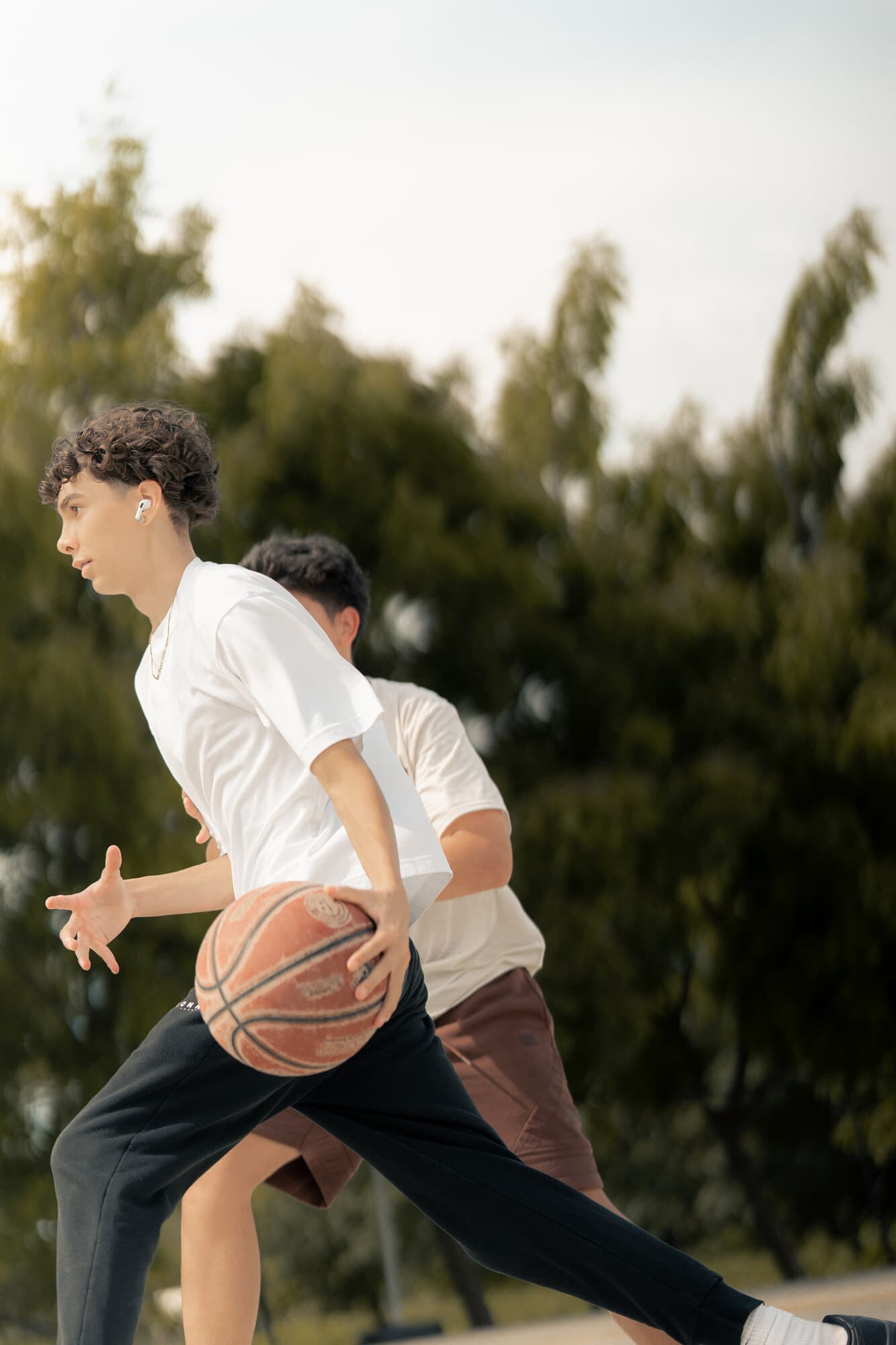 Tamarindo outdoor basketball court under tree shade