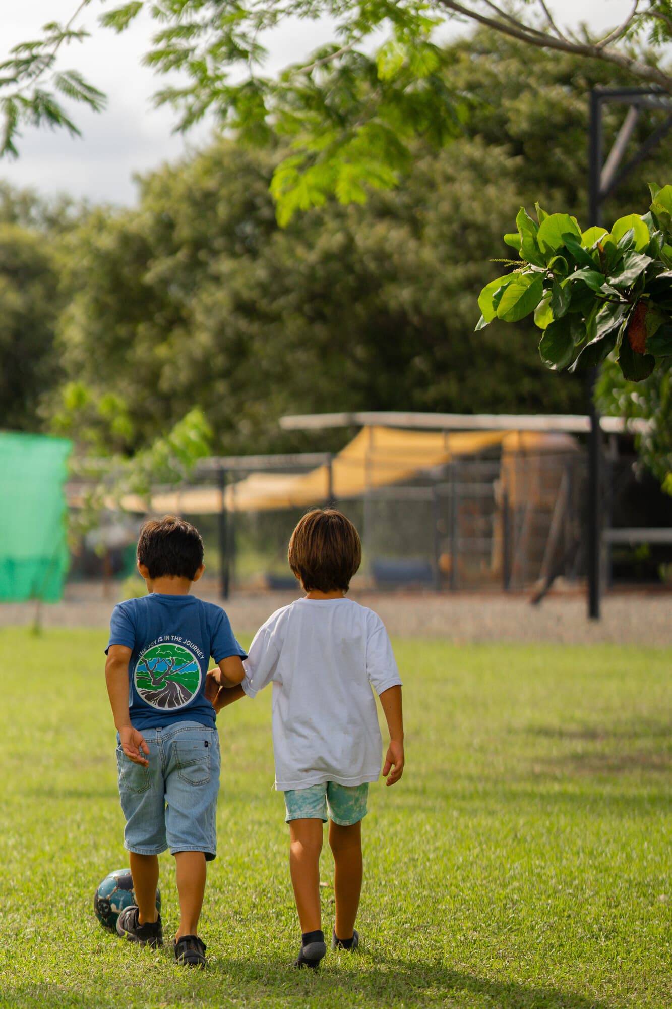 Young Tamarindo students running and playing on the open campus field
